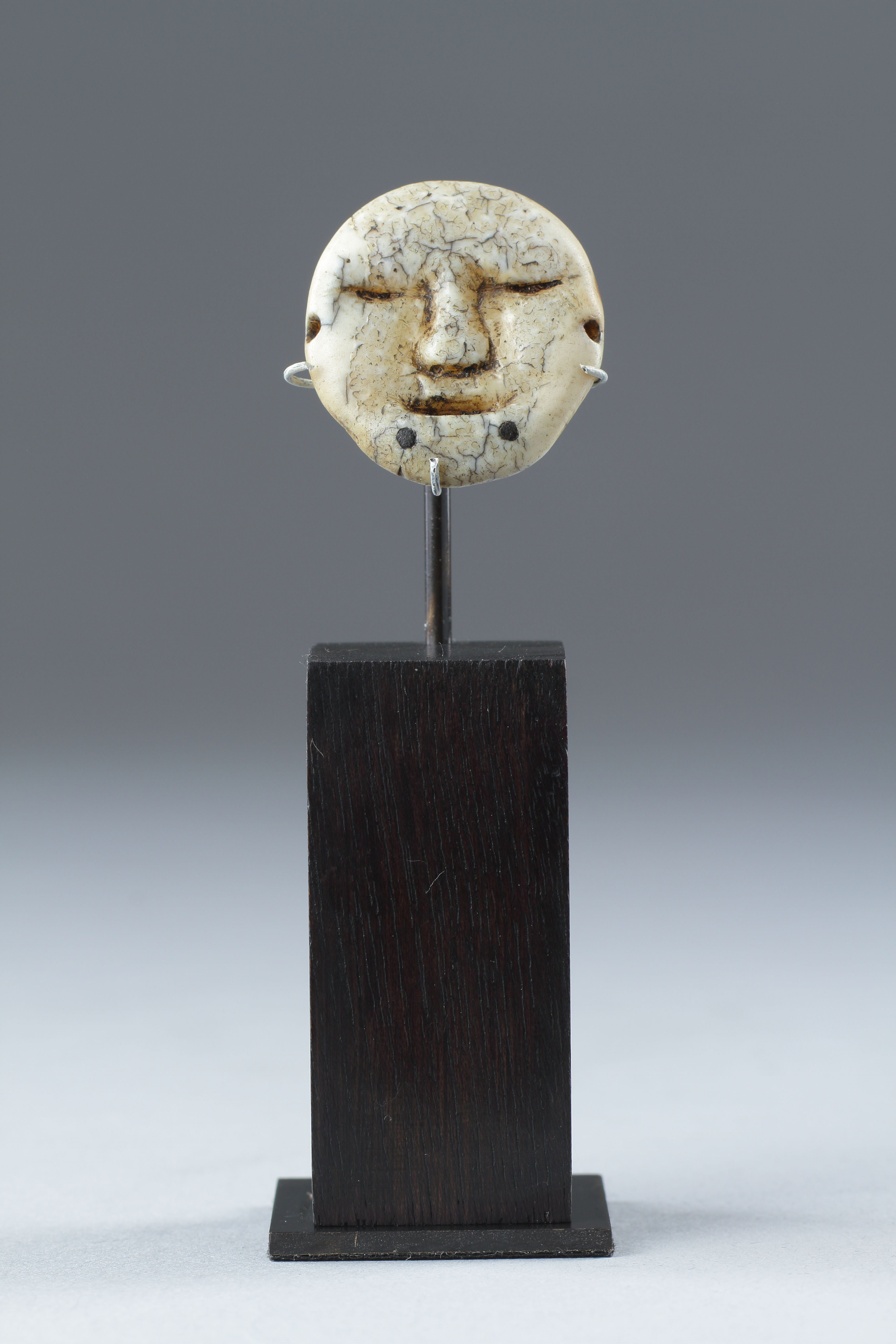 Bering Strait Eskimo Inuit carved walrus ivory earring in the form of a human face 